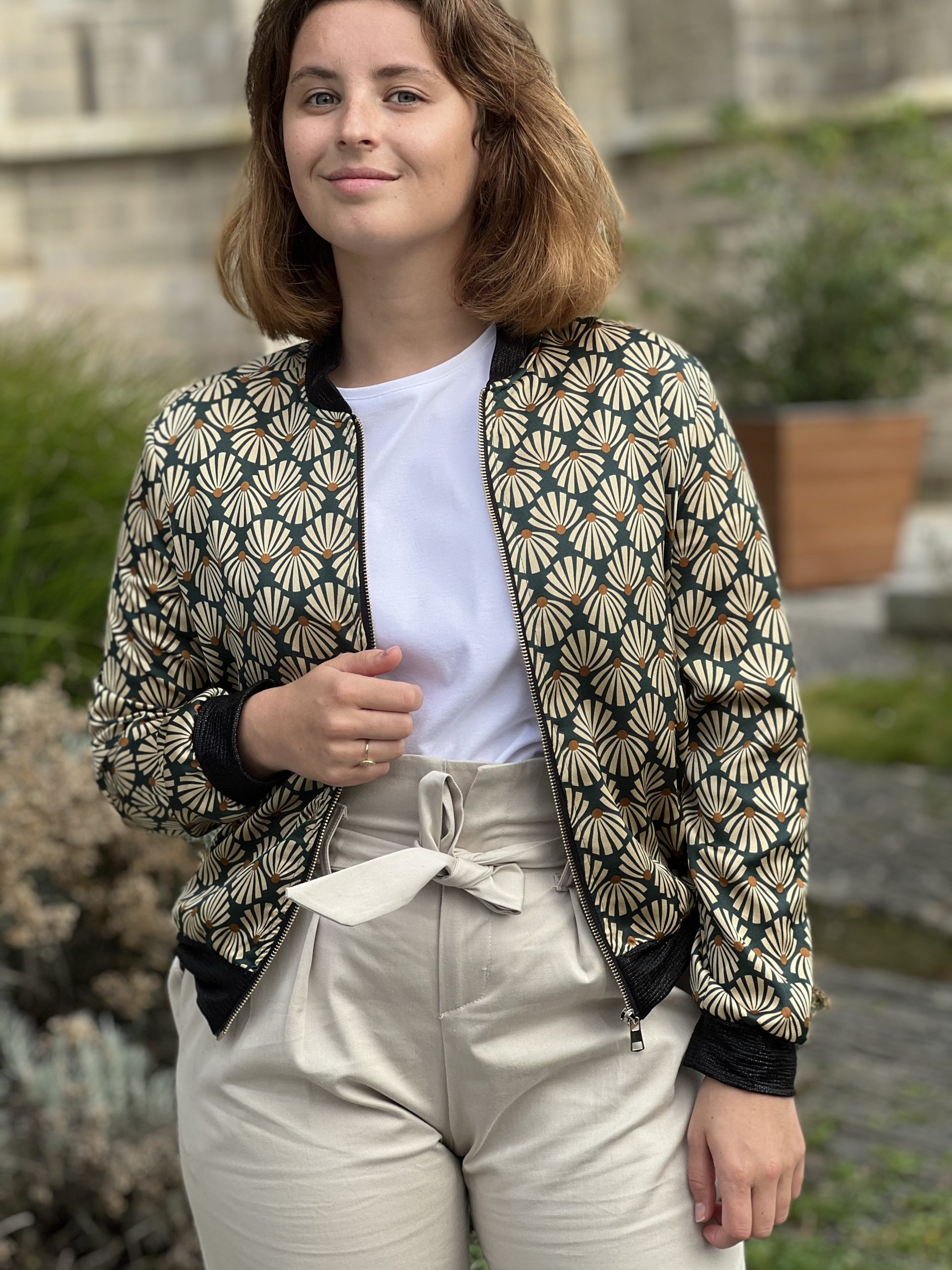 C'est une petite veste "Bomber" de couleur beige, vert, camel. Elle est courte avec fermeture éclair, finitions côtelées, noire sur l’encolure, taille et les poignets. Ce blouson est idéal pour le quotidien.